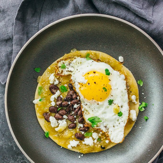 These healthy huevos rancheros are so easy and they make for a delicious breakfast; my favorite toppings include salsa verde, black beans, and crumbled Mexican cheese.