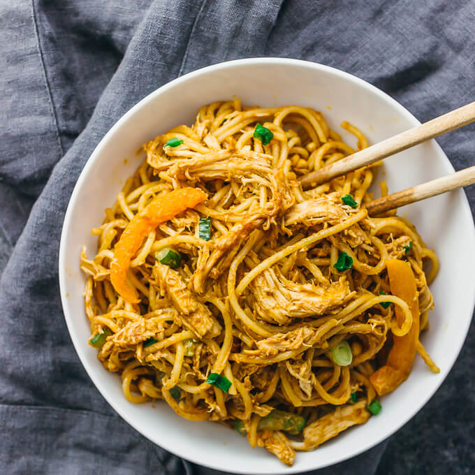 overhead view of peanut noodles served in a white bowl