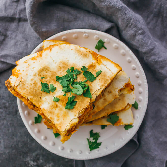 Calling all spicy food lovers: this quesadilla is filled with smoked salmon, black olives, jalapeños, pepper jack cheese, and a garlic-sriracha mayo sauce.
