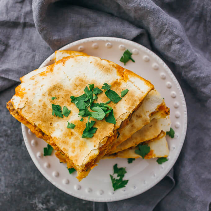 Calling all spicy food lovers: this quesadilla is filled with smoked salmon, black olives, jalapeƱos, pepper jack cheese, and a garlic-sriracha mayo sauce.