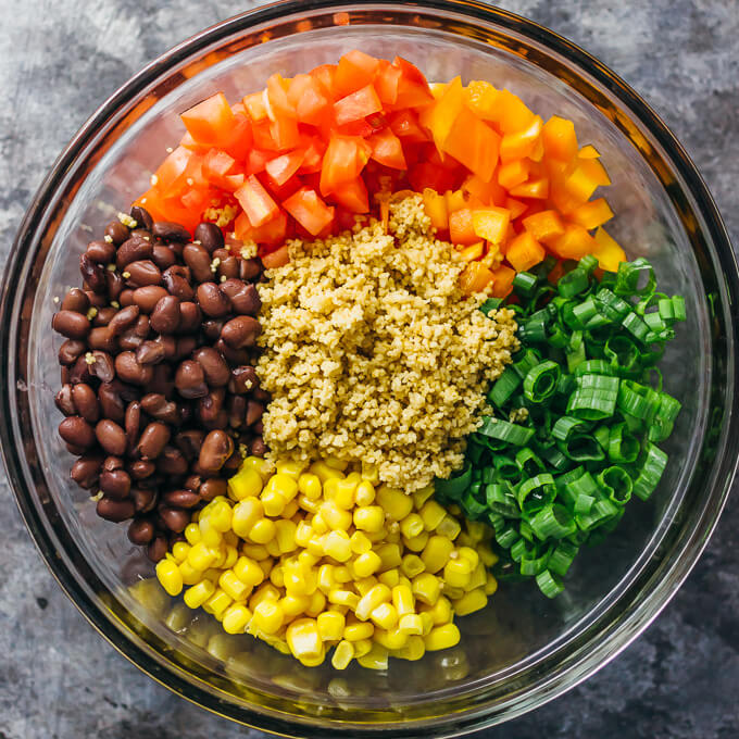 southwest couscous salad ingredients in glass bowl