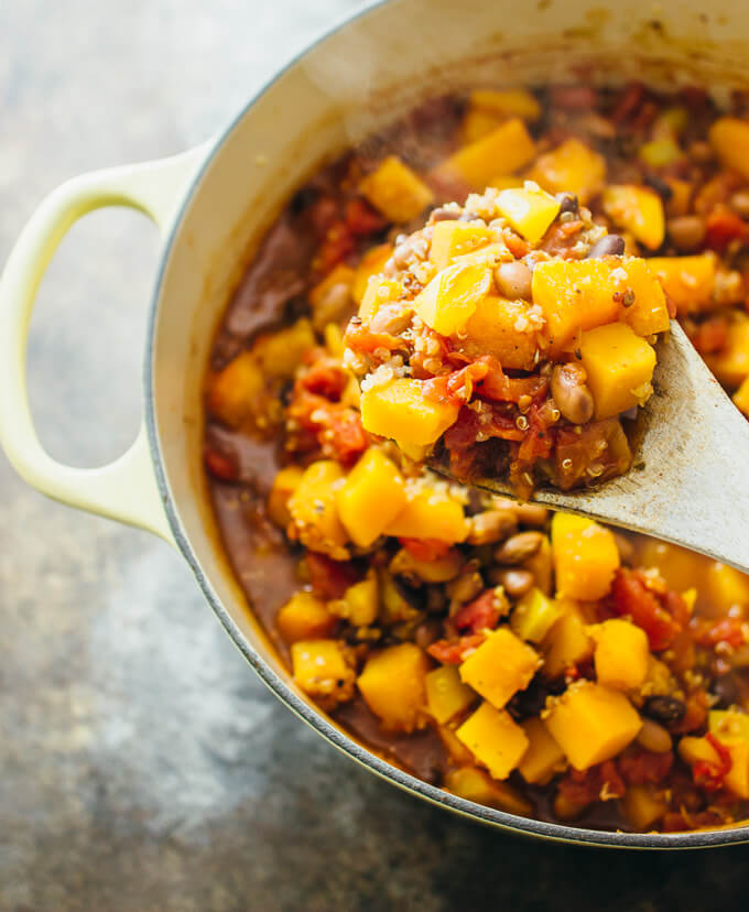 scooping up chili from a dutch oven