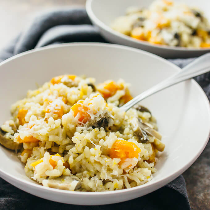 butternut squash risotto served in white bowls