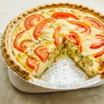 a quiche with bacon, broccoli, and tomato