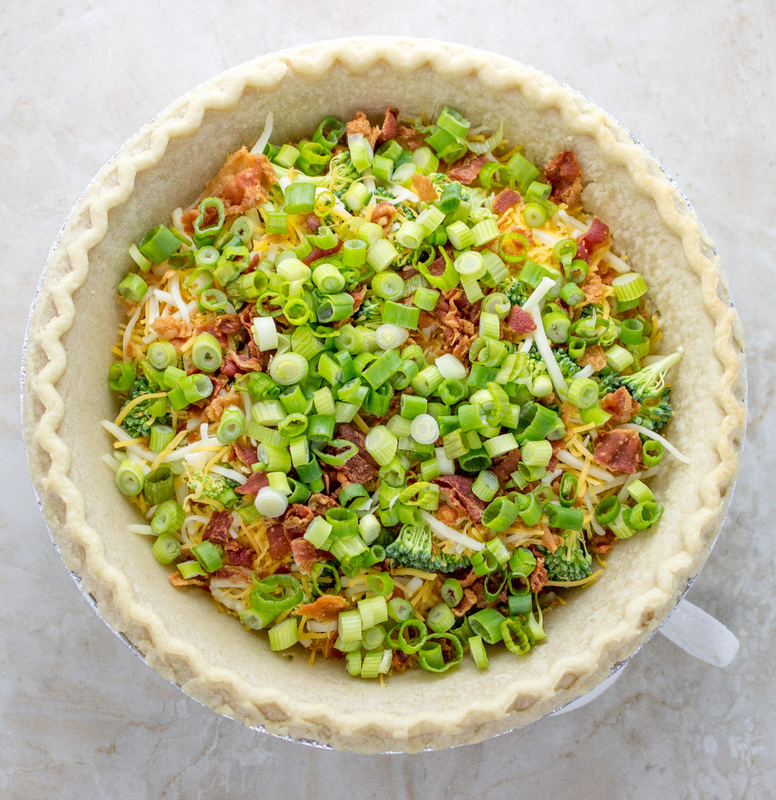 adding sliced scallions to a quiche