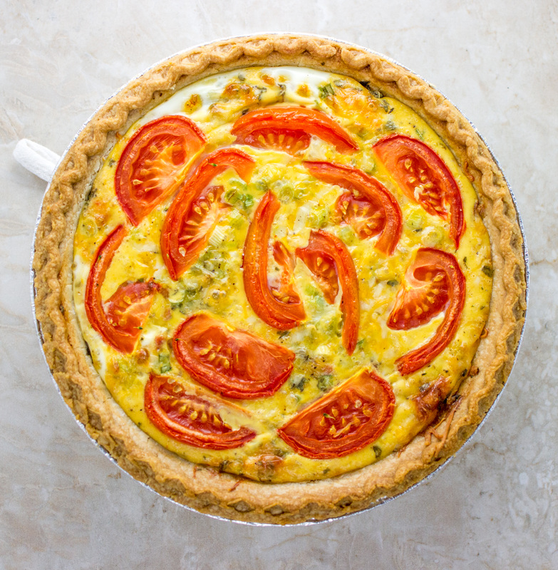 a quiche with bacon, broccoli, and tomato