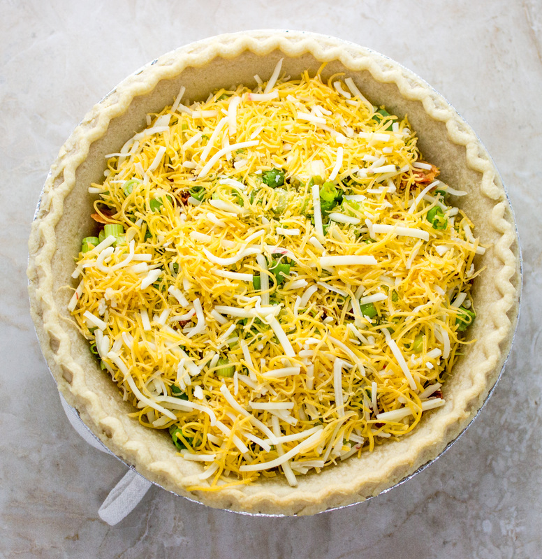 adding cheese during quiche assembly