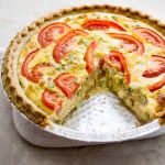 a quiche with bacon, broccoli, and tomato