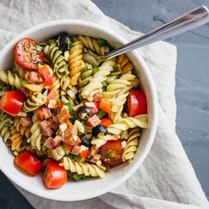 pasta salad served in white bowl