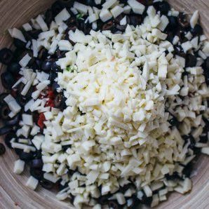 Best pasta salad recipe ingredients including sliced black olives and diced asiago cheese
