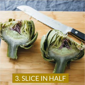 Photo shows how to eat artichokes by first slicing in half