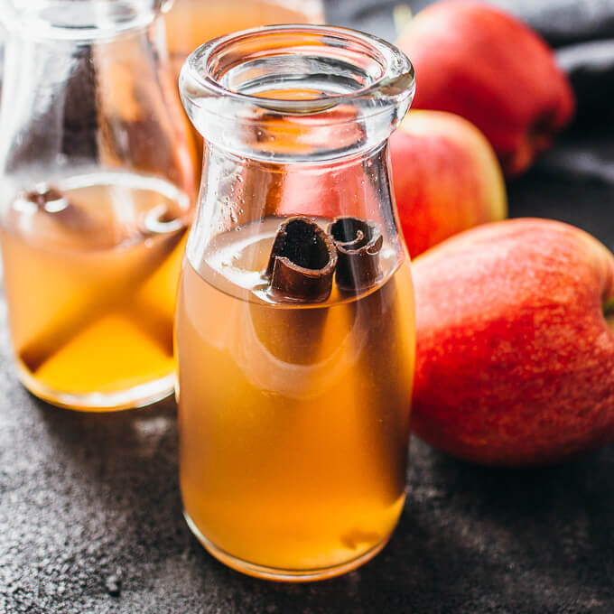 a glass of cranberry apple cider