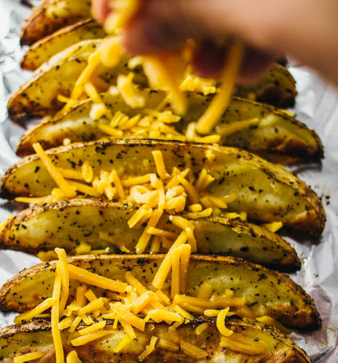 Baked potato wedges with melted cheddar cheese