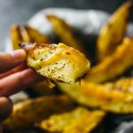 Baked potato wedges with melted cheddar cheese