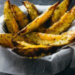 Baked potato wedges with melted cheddar cheese