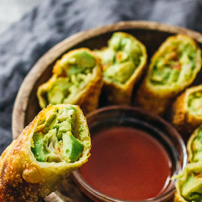 lifting up one avocado egg roll