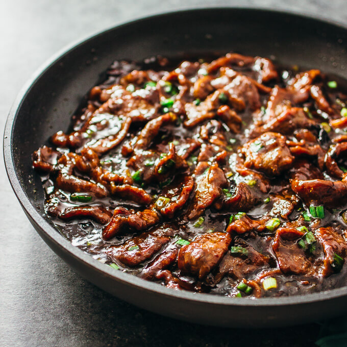 cooking mongolian beef in black skillet