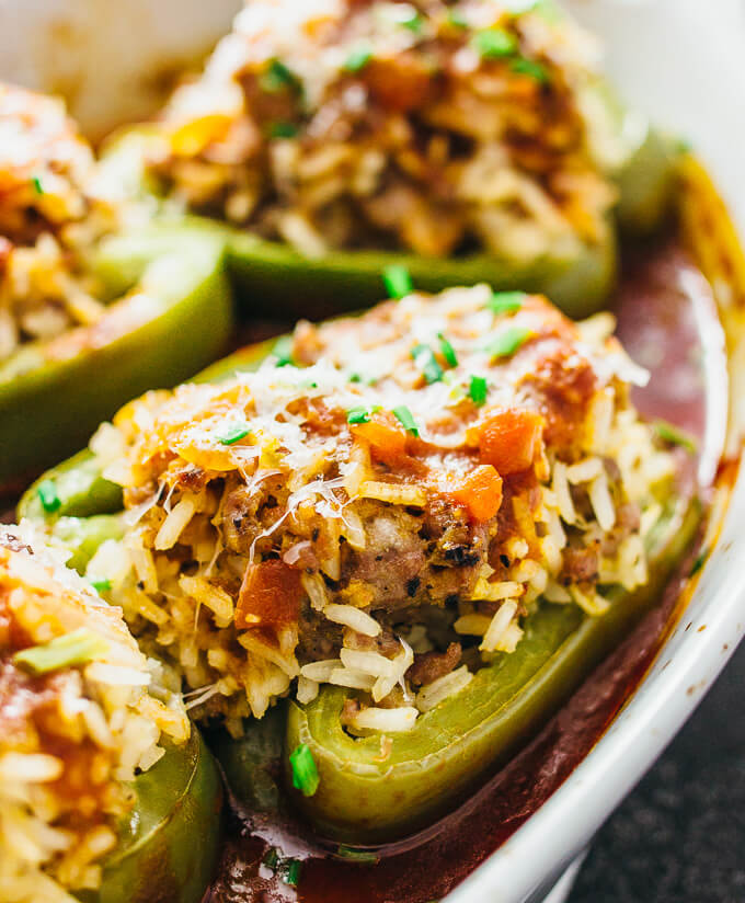 italian stuffed peppers with tomato sauce in baking dish