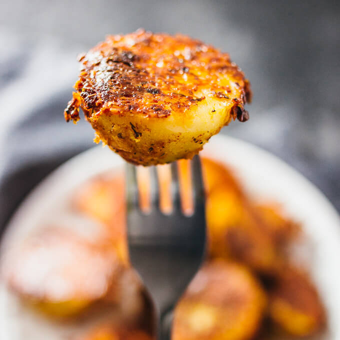 holding up a parmesan crusted potato on a fork