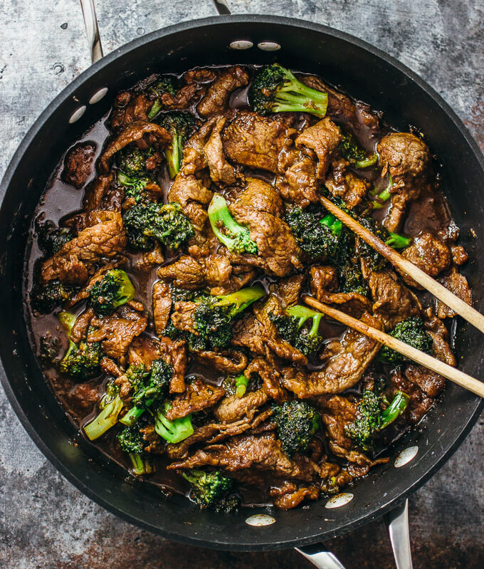 beef and broccoli cooking in black pan