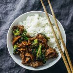 overhead view of beef and broccoli in white bowl