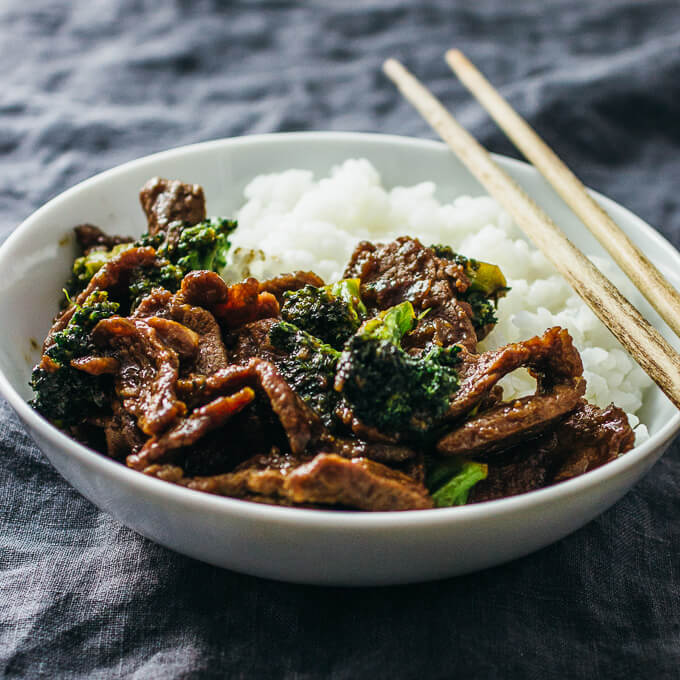 Tender beef slices and broccoli served in a white dinner bowl