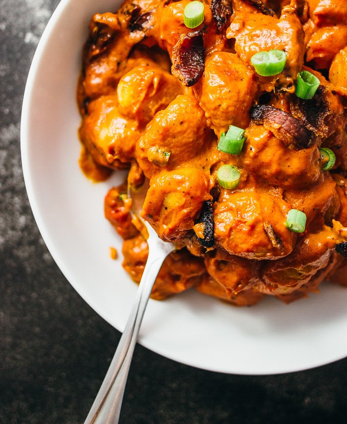 You'll love this spicy gnocchi arrabbiata pasta recipe with crispy crumbled bacon and sun-dried tomatoes simmered in a rich and creamy tomato sauce.