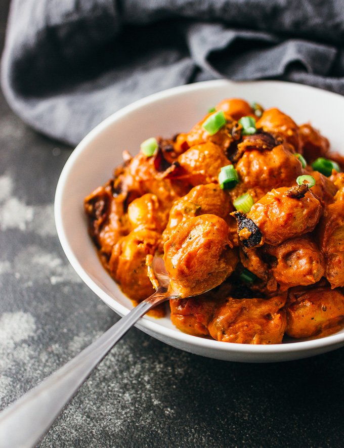 You'll love this spicy gnocchi arrabbiata pasta recipe with crispy crumbled bacon and sun-dried tomatoes simmered in a rich and creamy tomato sauce.