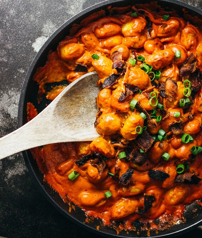 You'll love this spicy gnocchi arrabbiata pasta recipe with crispy crumbled bacon and sun-dried tomatoes simmered in a rich and creamy tomato sauce.