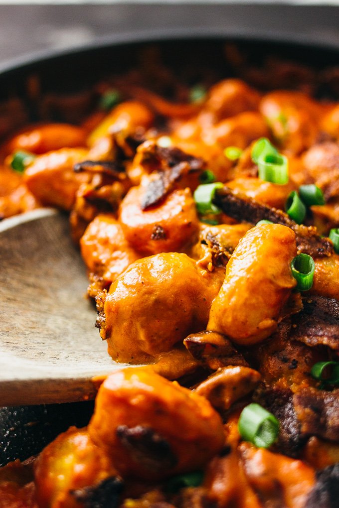 You'll love this spicy gnocchi arrabbiata pasta recipe with crispy crumbled bacon and sun-dried tomatoes simmered in a rich and creamy tomato sauce.