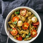 Easy caprese pasta salad with cherry tomatoes, mozzarella, and basil