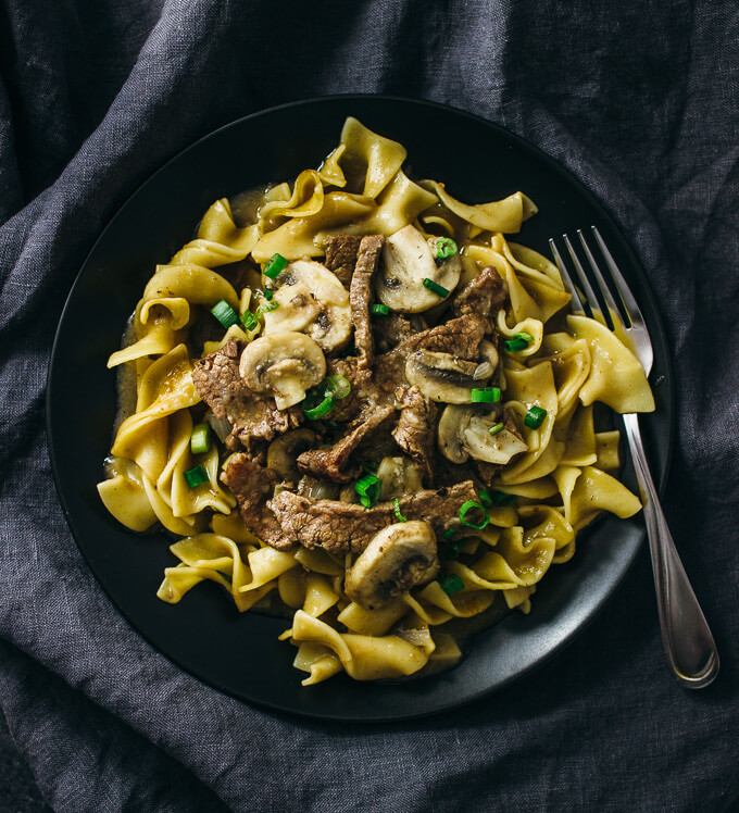 beef stroganoff served on a black plate