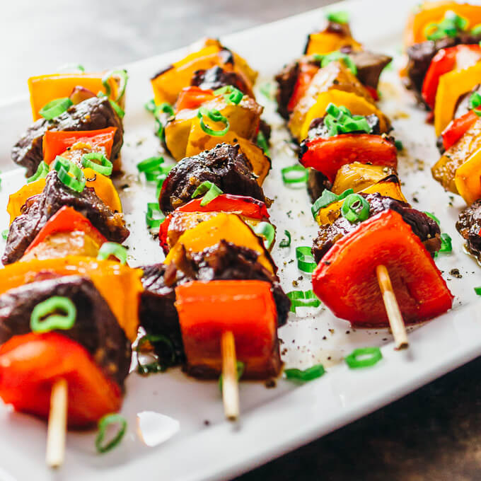 hawaiian steak kabobs served on white platter