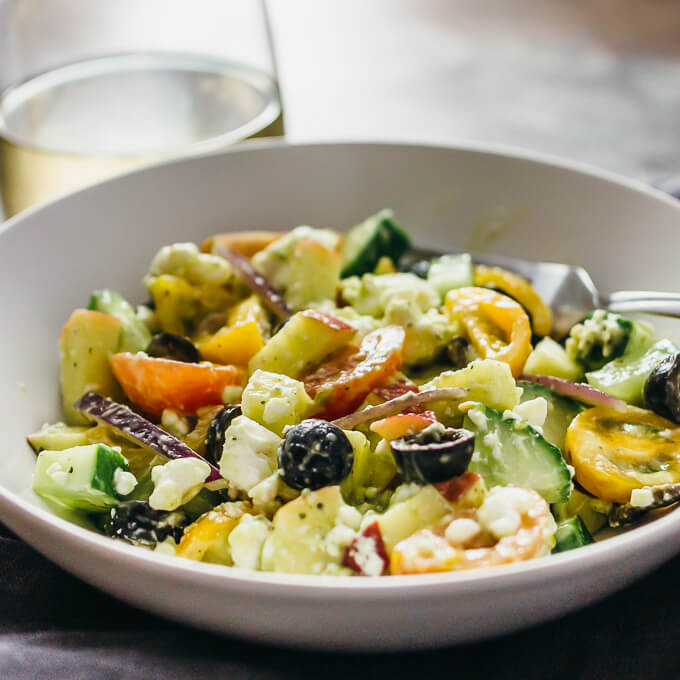 greek salad served in white bowl