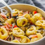 This tortellini pasta salad with Italian dressing is a quick and easy recipe, and deliciously packed with mixed olives, salami, and cheese.