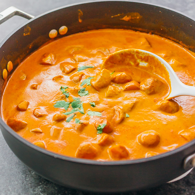 potato curry cooking in black pan