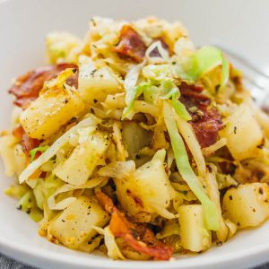 fried cabbage and potatoes served in white bowl