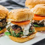 greek burgers served on a white platter