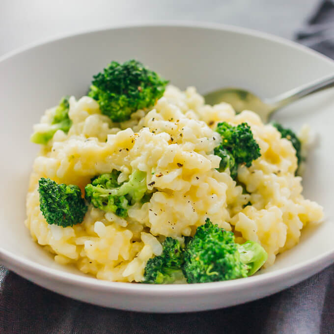 One pot vegetarian broccoli cheddar risotto served in a white bowl