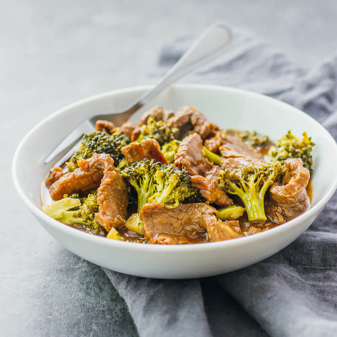 beef and broccoli served in a white bowl