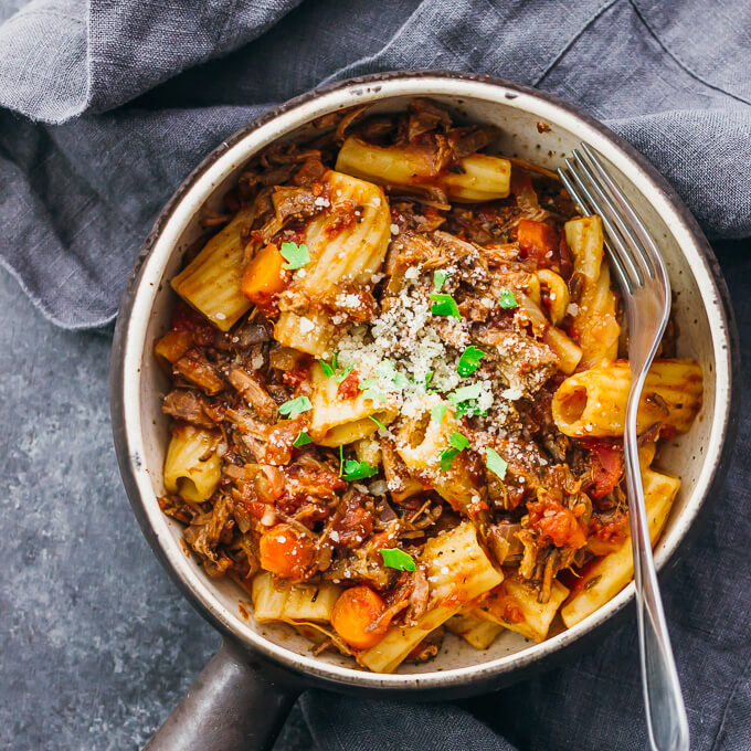 Beef ragu rigatoni in a serving bowl with fork