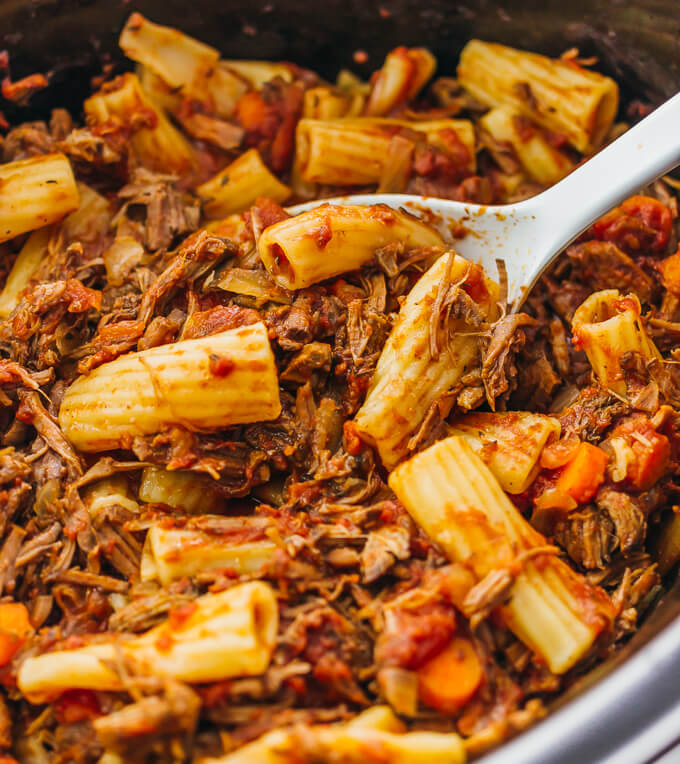 Here's a recipe that really makes the slow cooker shine: deliciously tender shredded beef ragu sauce paired with rigatoni pasta.