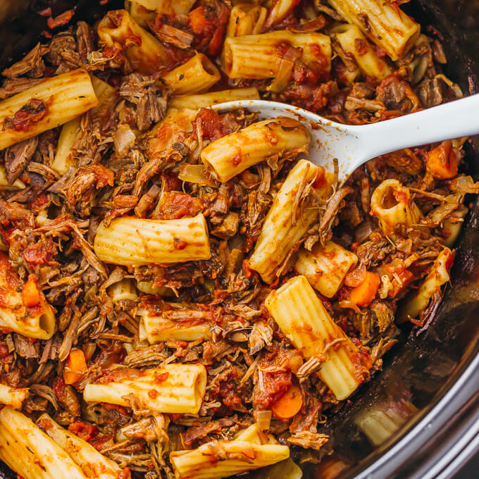 Here's a recipe that really makes the slow cooker shine: deliciously tender shredded beef ragu sauce paired with rigatoni pasta.