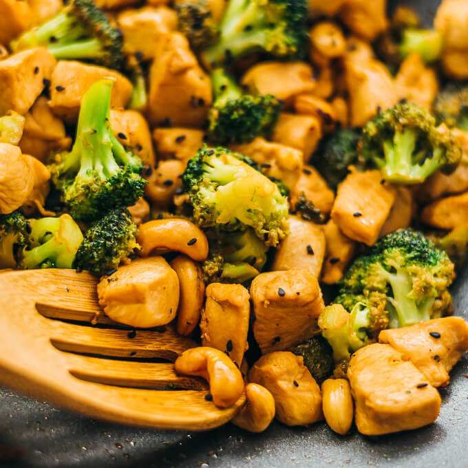 stirring cashew chicken and broccoli in wok