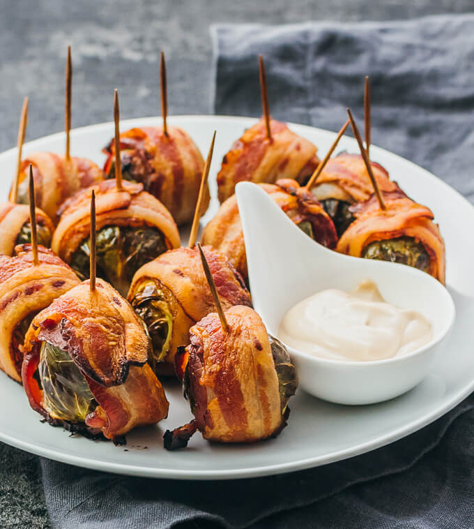 bacon wrapped brussels sprouts served on white plate