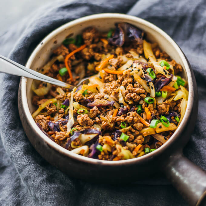 Cabbage and ground beef stir fry dinner served in a bowl with a fork