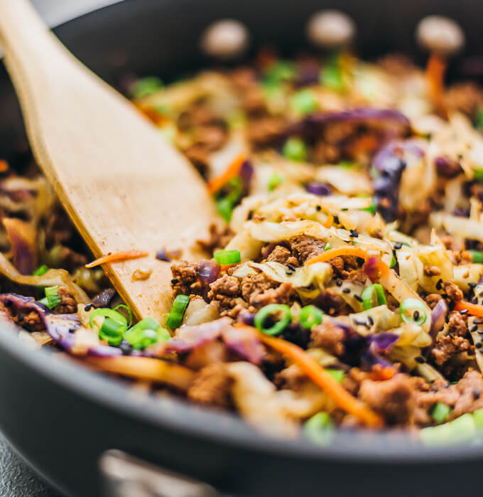 closeup view of stirring beef with cabbage