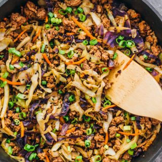 stirring cabbage and ground beef in skillet