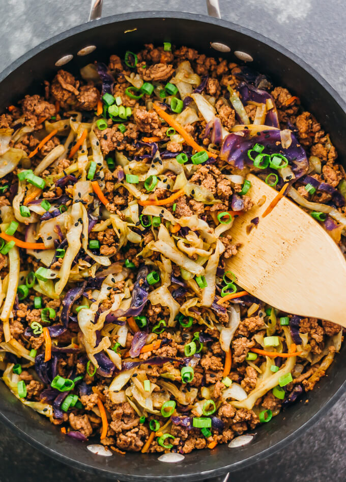 stirring cabbage and ground beef in skillet