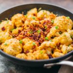 This easy roasted cauliflower is a super comforting low-carb meal, loaded with bacon and cheese.